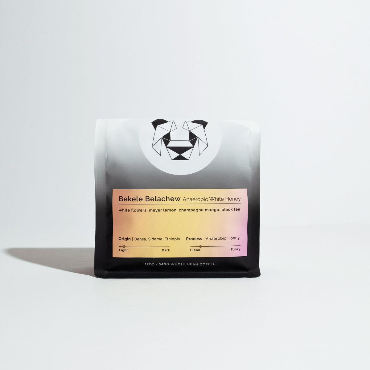 12 oz bag of Bekele Belachew Anaerobic White Honey coffee, featuring flavor notes and origin details, with a geometric animal logo on a gradient bag.