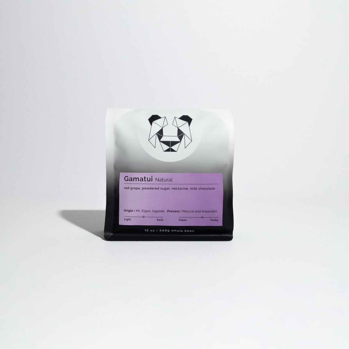 Close-up of a white and black bag labeled Gamatui - Natural featuring a panda logo, representing a specialty coffee from the Gamatui community in Uganda.