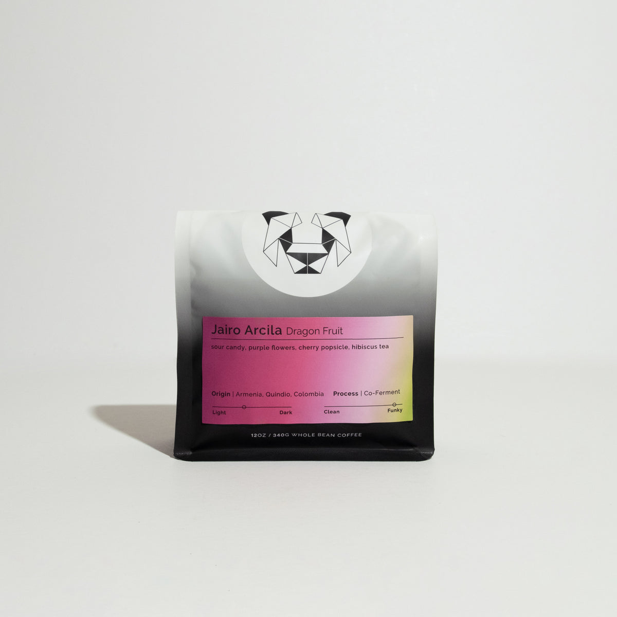 Jairo Arcila Dragonfruit coffee pouch features a geometric animal logo and gradient label detailing tasting notes, origin, and co-ferment process.