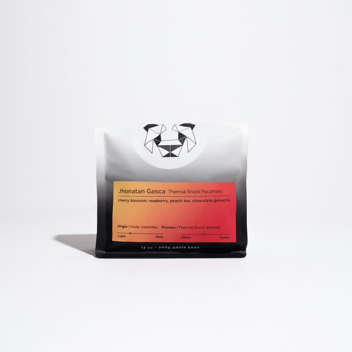 A bag of coffee on a white background with a yellow label that says Jhonatan Gasca Thermal Shock Pacamara with tasting notes of cherry blossom, raspberry, peach tea, chocolate ganache.