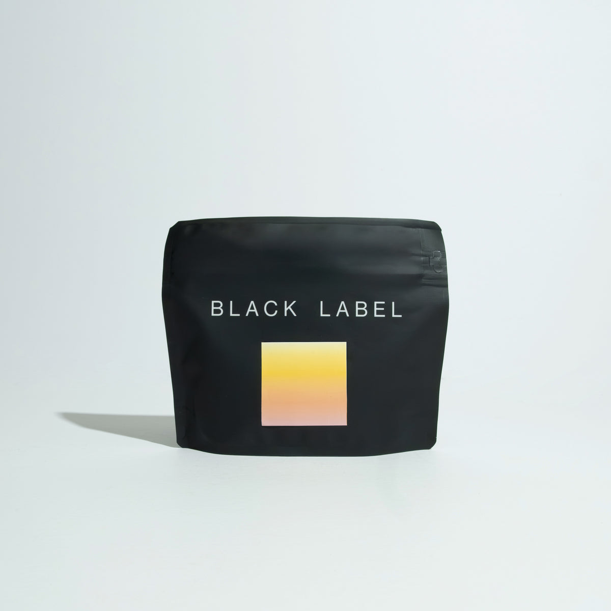 Matte-black pouch labeled BLACK LABEL, featuring a gradient block, contains Jose Jijón - Putushio Washed coffee, highlighting premium Ecuadorian coffee craftsmanship.