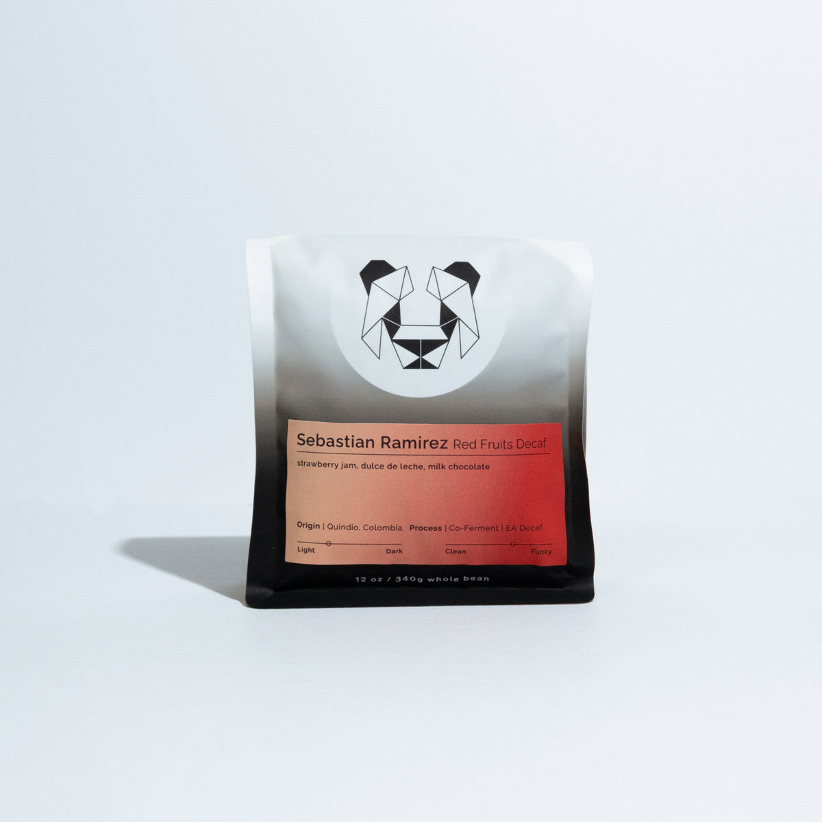 A single coffee bag from Sebastian Ramirez, featuring a white-to-black gradient package with a geometric panda logo and a red-orange label, photographed on a clean white background.