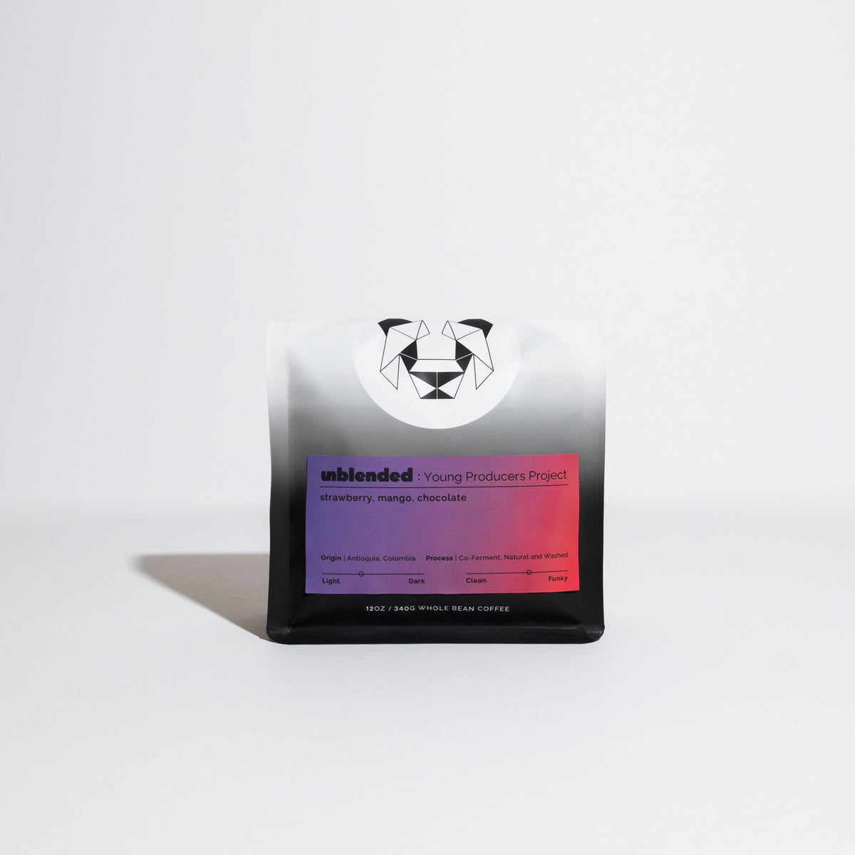 12 oz bag of Unblended Young Producers Project whole-bean coffee, featuring a panda logo, highlighting strawberry, mango, and chocolate notes. Origin: Antioquia, Colombia.
