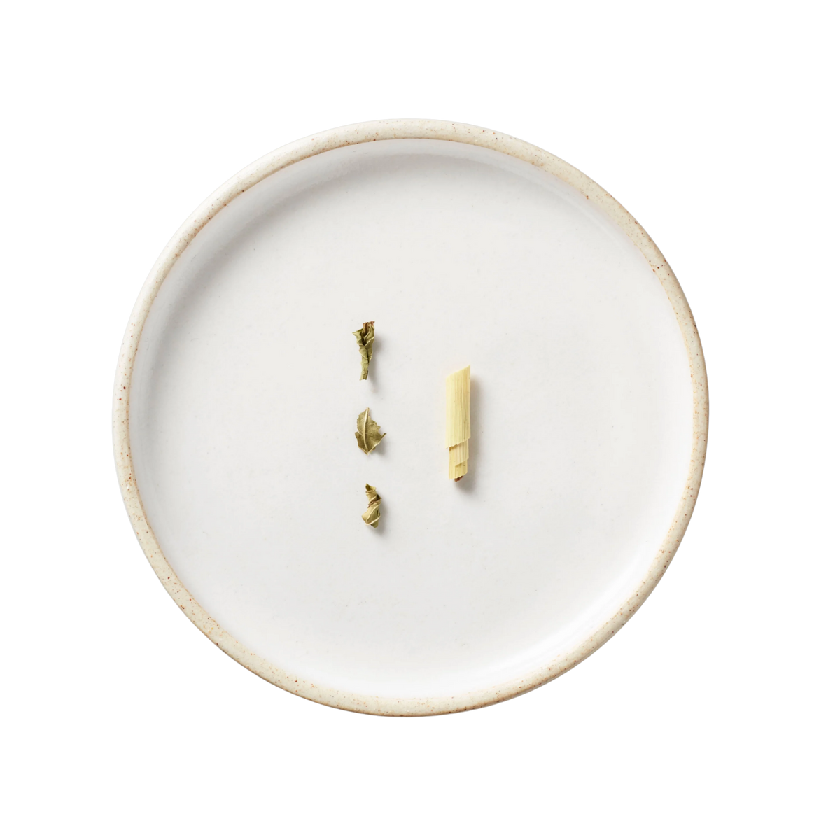 Rainier Tisane Blend: Minimalist display of lemongrass and dried leaves on a white ceramic plate, emphasizing the blend's organic ingredients and Pacific Northwest terroir.