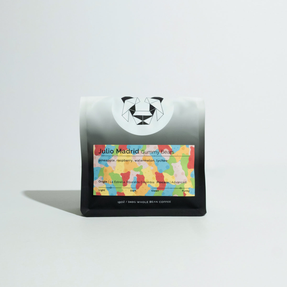 Matte-black coffee bag with geometric bear logo and colorful label reading Julio Madrid - Gummy Bears, featuring tasting notes of pineapple, raspberry, watermelon, and lychee.