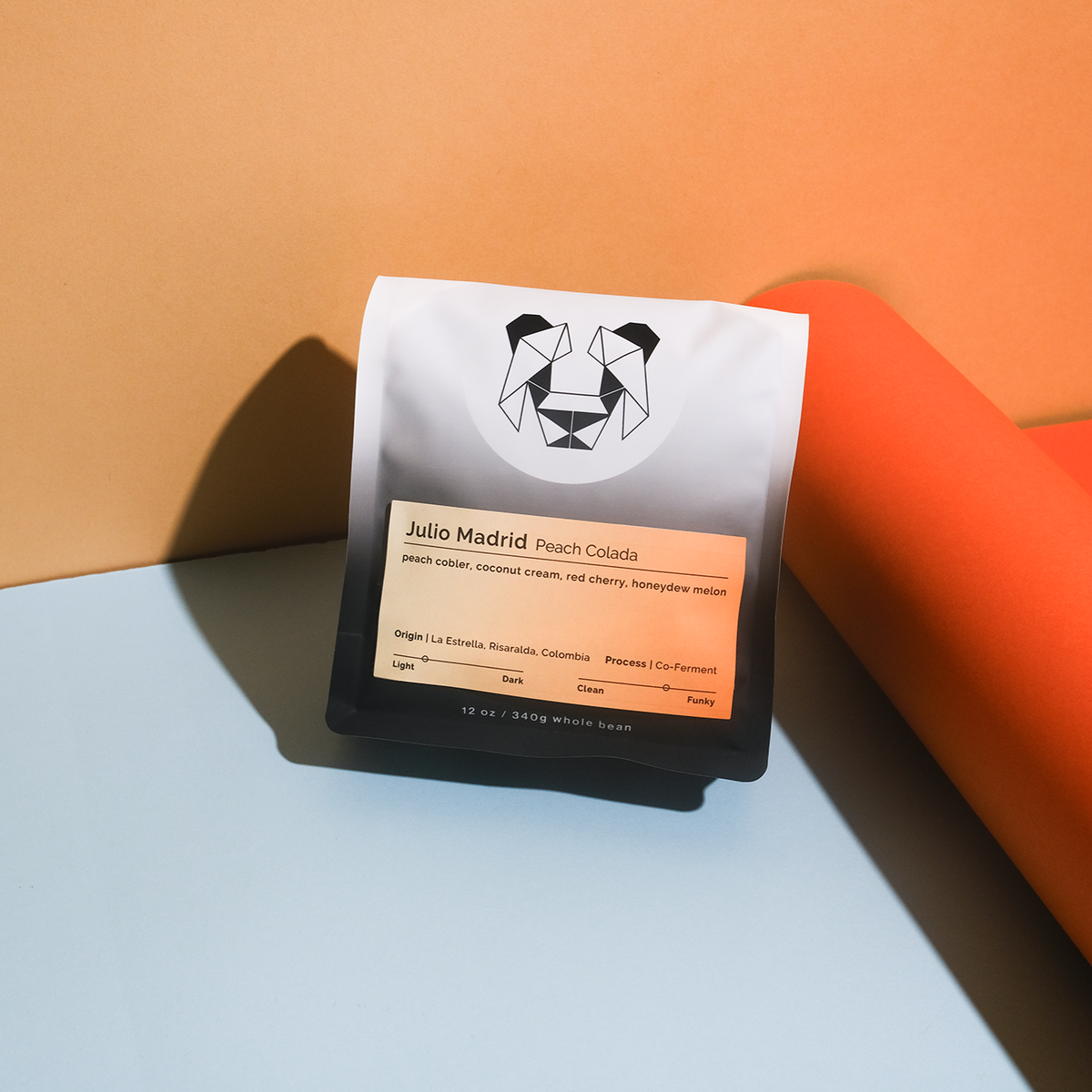 Julio Madrid - Peach Colada coffee blend, featuring Gesha beans co-fermented with peaches and coconut distillate, evoking peach cobbler and tropical flavors.