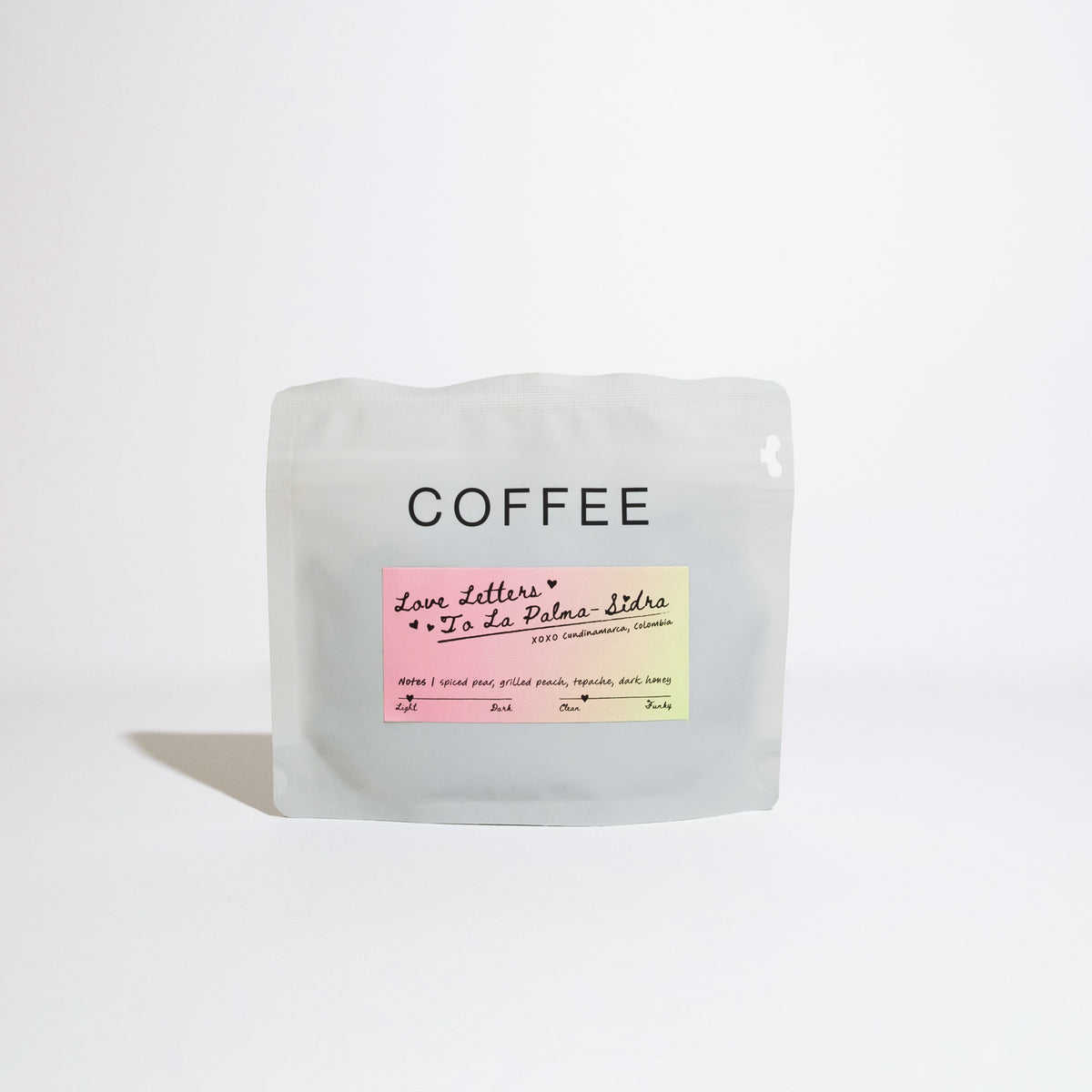 Resealable coffee pouch labeled Love Letters to La Palma with tasting notes of spiced pear, grilled peach, tepache, and dark honey, sourced from Cundinamarca, Colombia.
