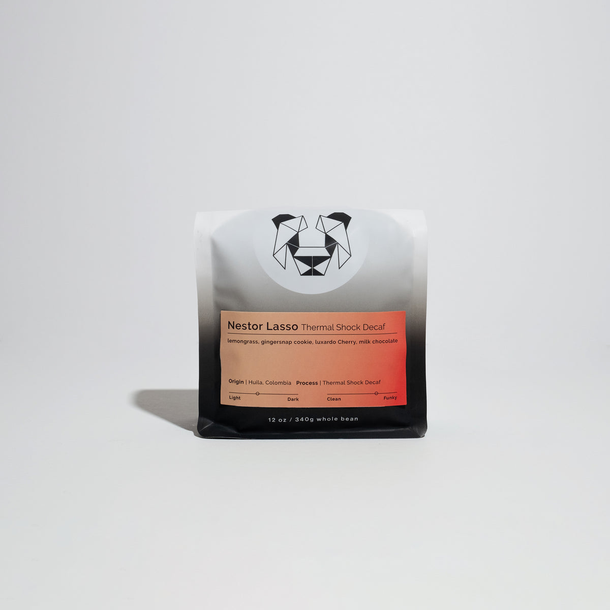 Nestor Lasso - Thermal Shock Decaf coffee beans, visibly red-ish and slightly oily, representing advanced processing and unique flavor notes from El Diviso farm.