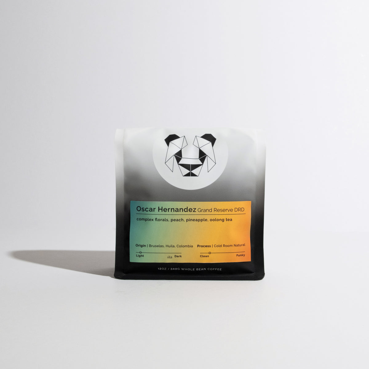 Oscar Hernandez - Grand Reserve DRD whole-bean coffee, 12 oz bag featuring a panda logo, sunset-hued label with tasting notes and origin details.