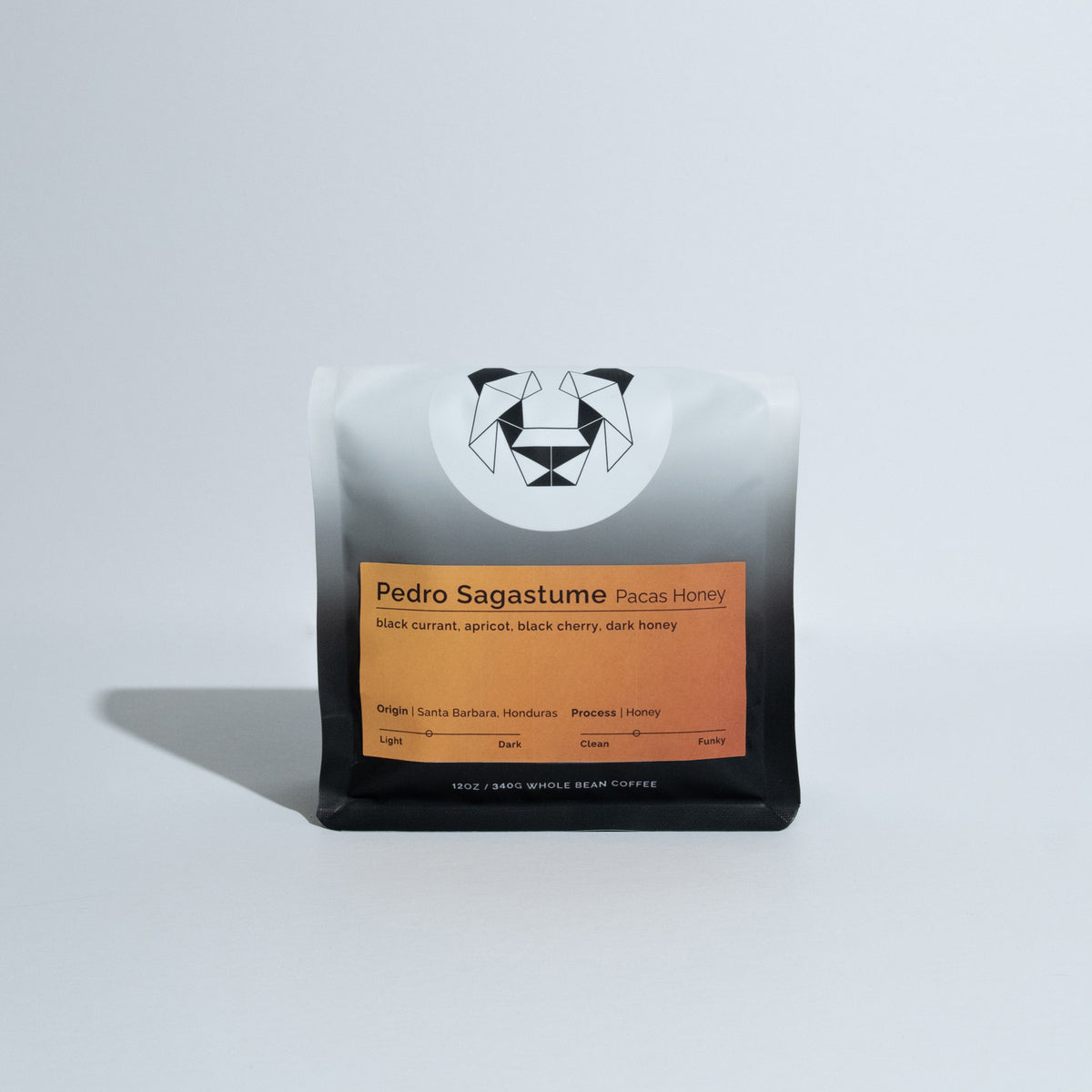 A bag of coffee on a white backdrop with a colorful label on it that says Pedro Sagastume Pacas Honey.