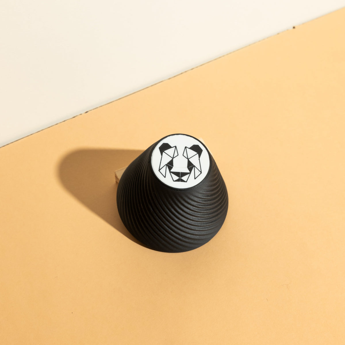 Pandagotiator accessory alongside Orea V3 dripper, emphasizing precision in coffee brewing with a compact, intricately designed tool for consistent filter folding.